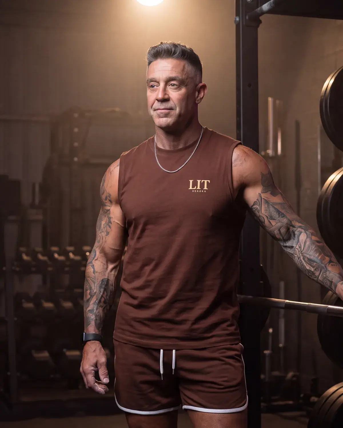 Kory in the gym, beside a loaded barbell