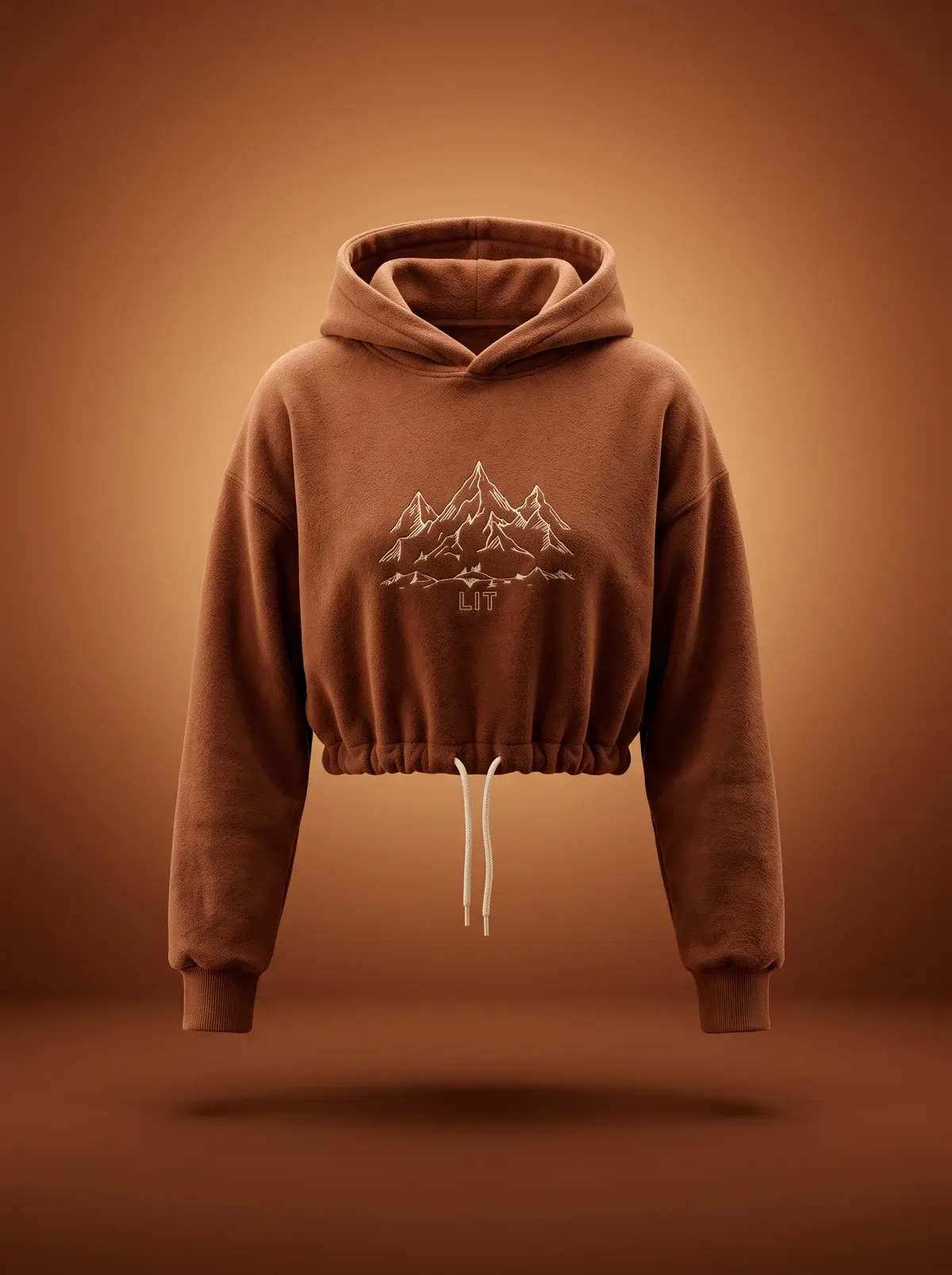 Cropped Mountain Hoodie — Rust in Summit Rust, photographed front-on against a paper ground.